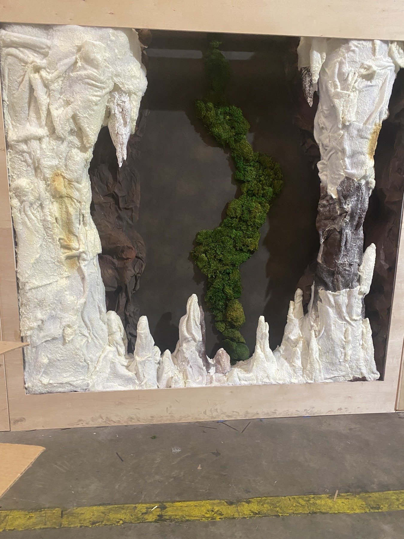 The installation framework with sculpted rock forms and moss.